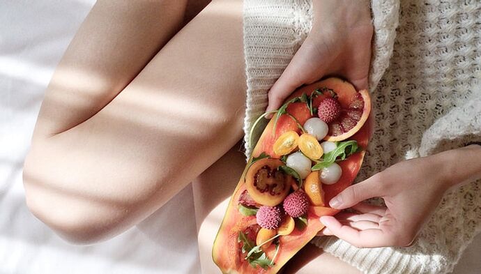 Girl with papaya and other fruits